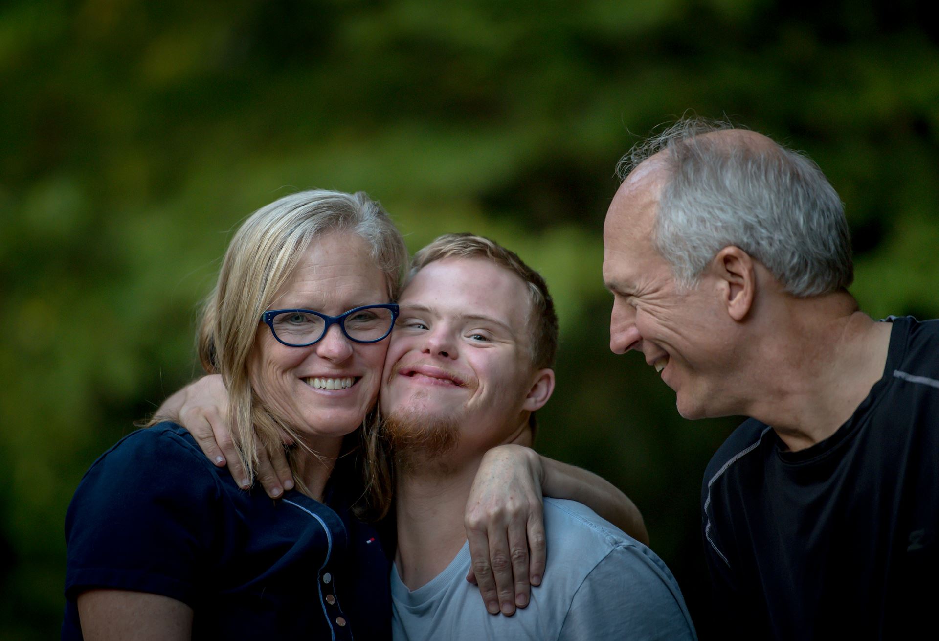 Family hugging and smiling